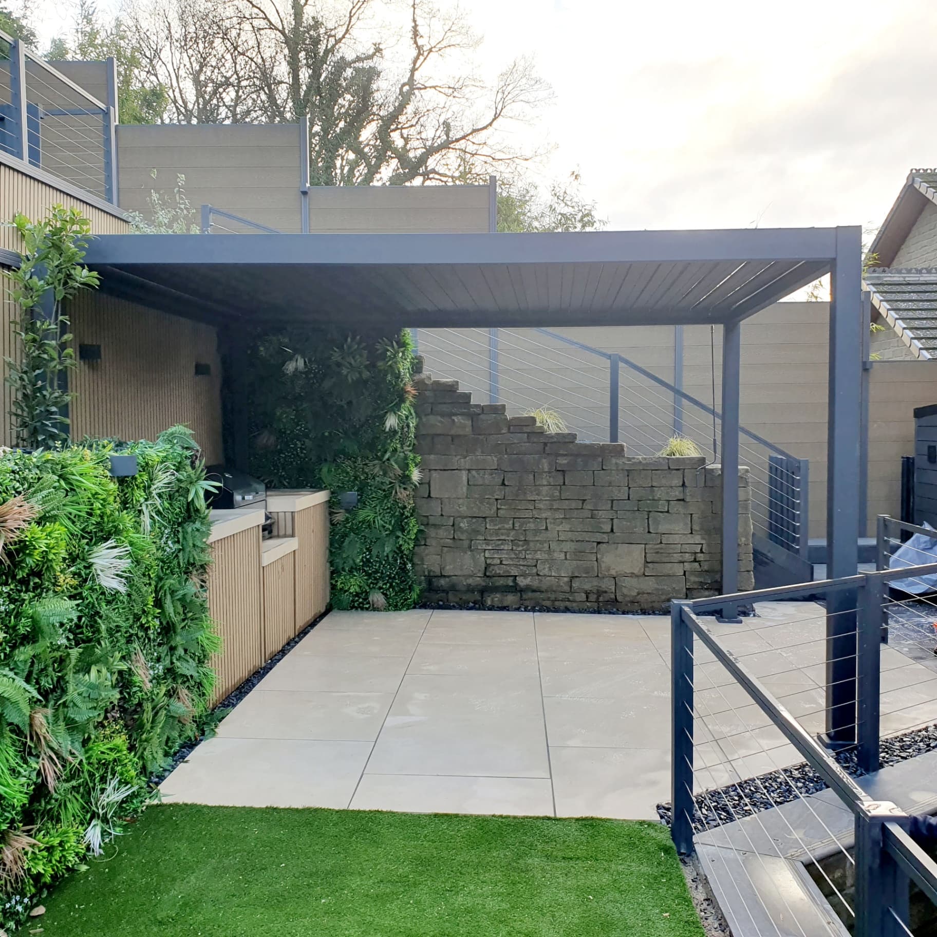 Outdoor kitchen with green wall border Sheffield